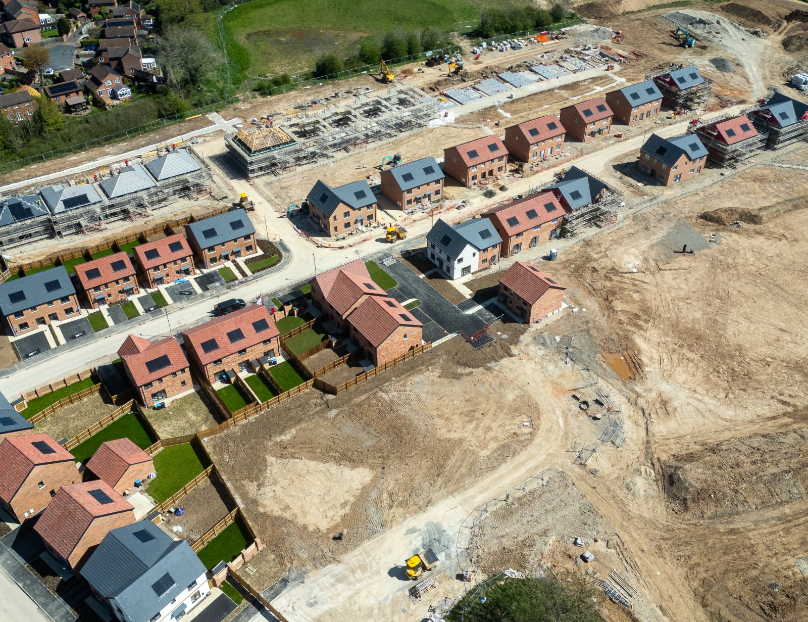 Aerial view of developed land with homes under construction
