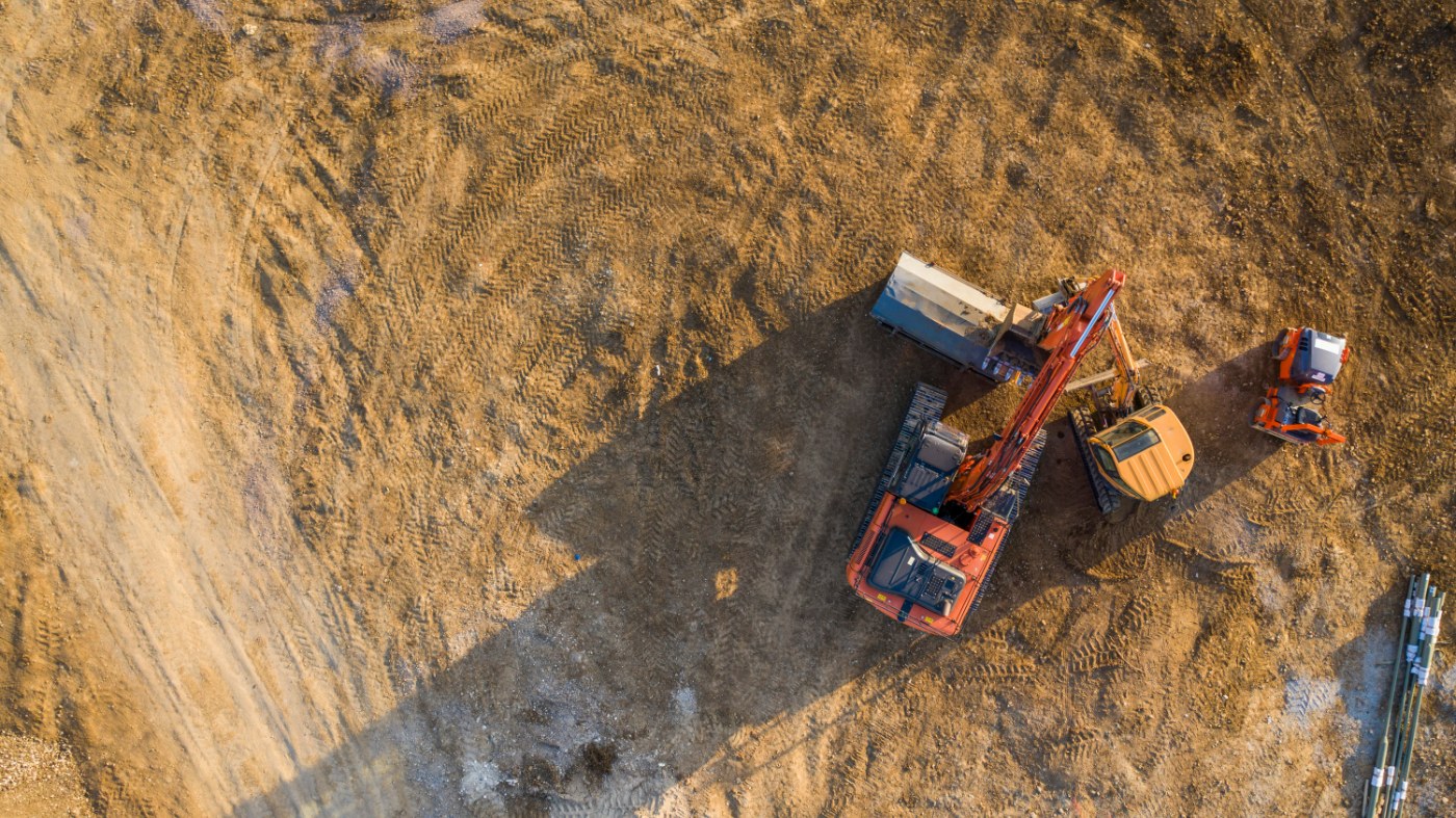 Excavator and dump truck moving dirt on a development site
